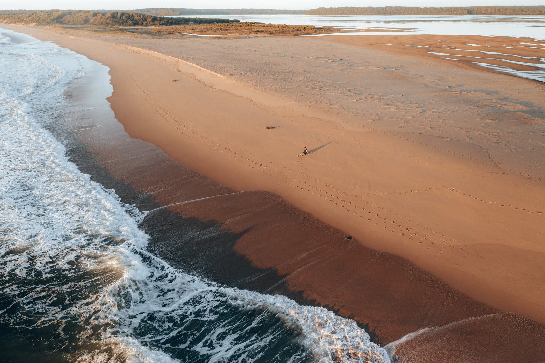 sandy beach with foamy waves