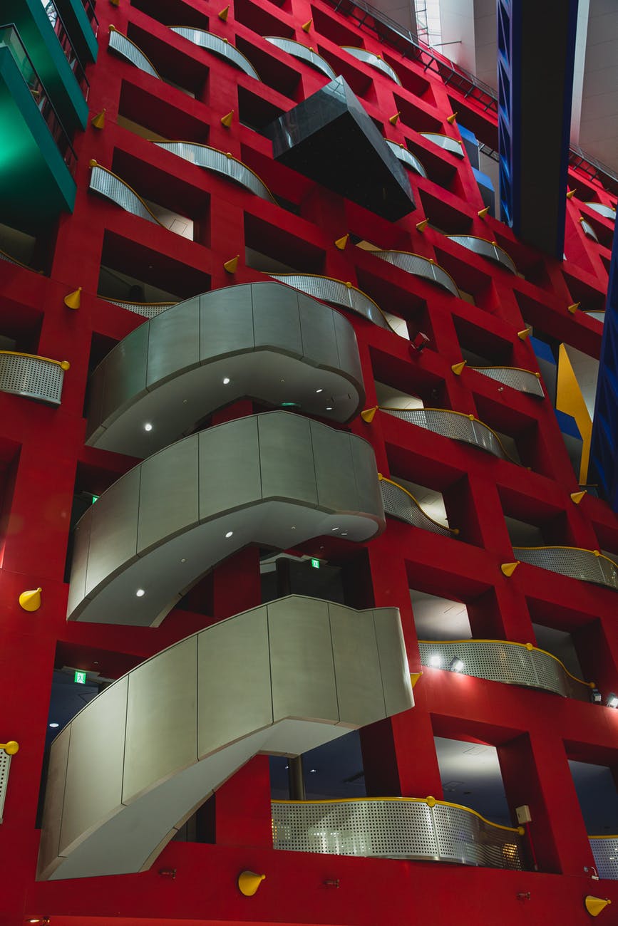 futuristic building with glowing lights on balconies