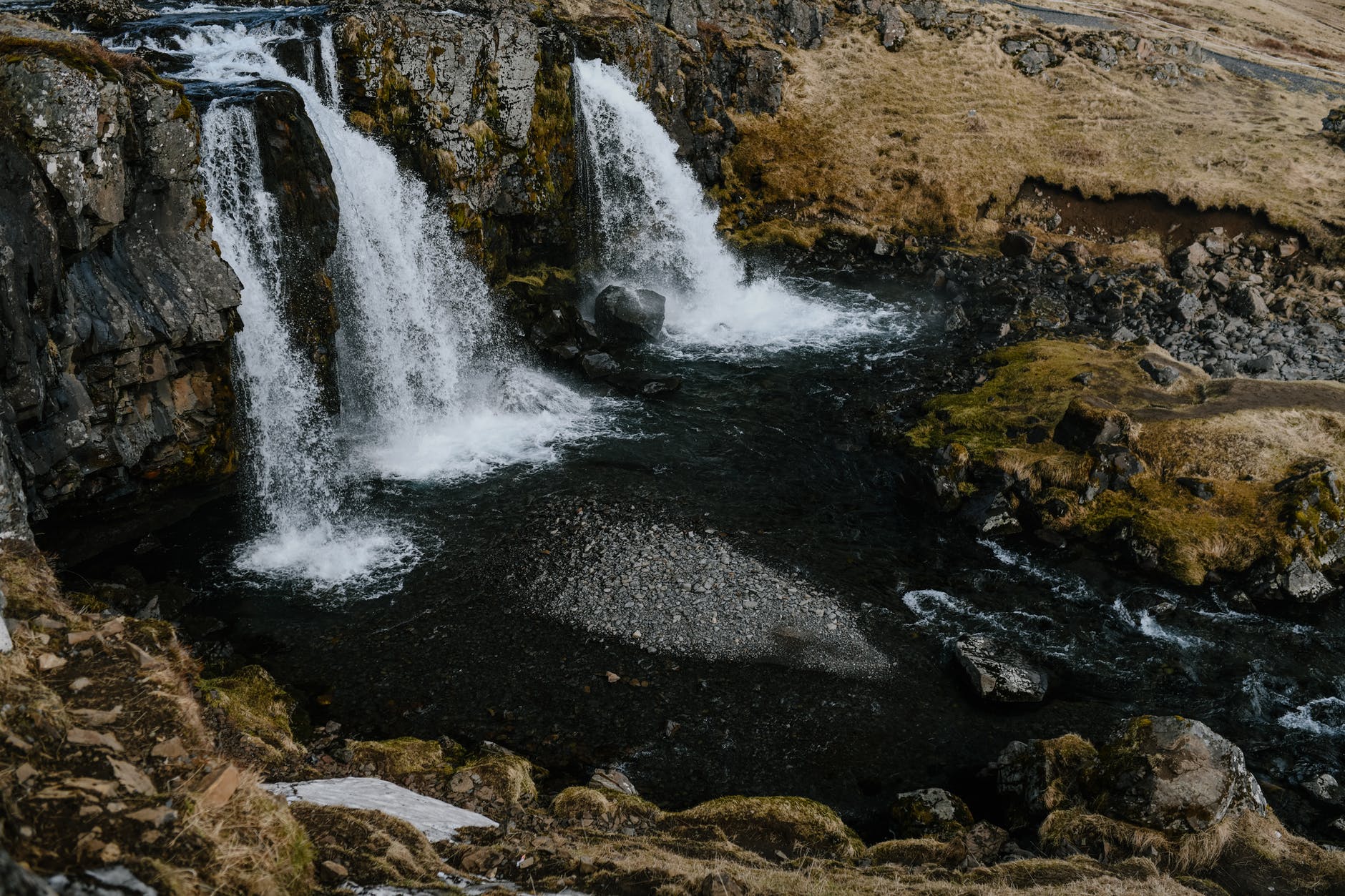 waterfalls cascading near the rocky field